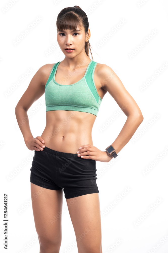 Fitness woman wearing smart watch isolated in white background. Asian girl, confident pose. Fitness woman wearing smart watch isolated in white background. Asian girl, confident pose.