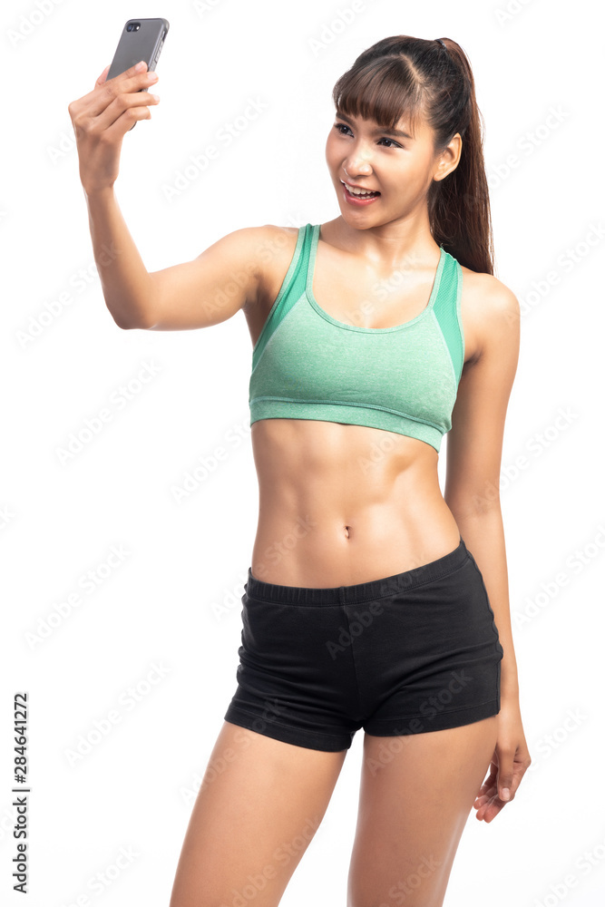 Fitness woman using mobile phone. Asia girl, doing selfie. Fitness woman using mobile phone. Asia girl, doing selfie.