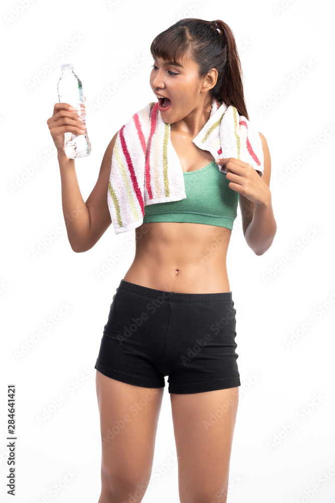 Fitness woman resting isolate in white background. Asian girl with water bottle and towel. Surprise look. Fitness woman resting isolate in white background. Asian girl with water bottle and towel. Surprise look.