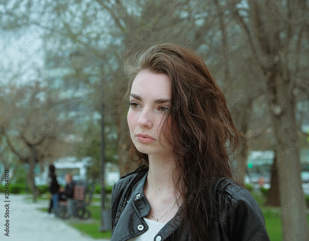 Calm girl with windy hair headshot in green tones Calm girl with windy hair headshot in green tones