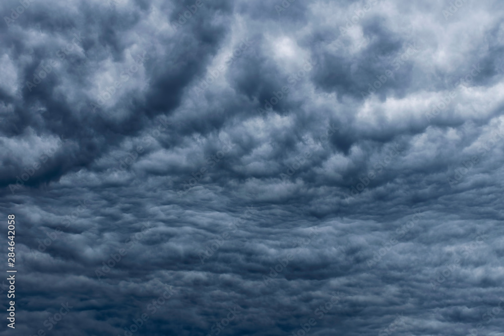 Dark sky, white fluffy and rainy dark clouds before rain. Background texture. Dark sky, white fluffy and rainy dark clouds before rain. Background texture.