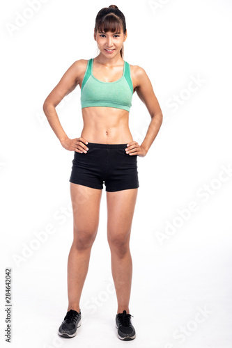 Fitness woman isolated in white background. Asian girl in full body pose. Happy smile.