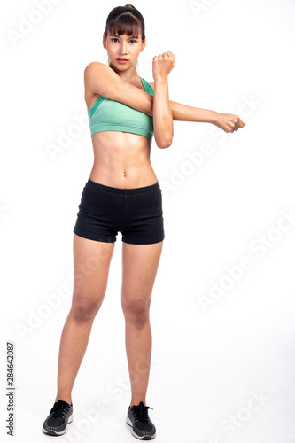 Fitness woman stretching isolated in white background. Asian girl in full body shot. Right arm stretch.