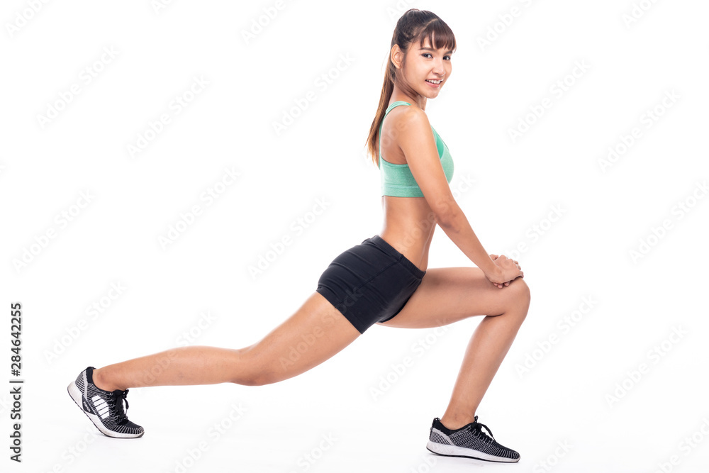 Fitness woman stretching isolated in white background. Asian girl in full body shot. Thigh muscle stretch, side shot with smile. Fitness woman stretching isolated in white background. Asian girl in full body shot. Thigh muscle stretch, side shot with smile.