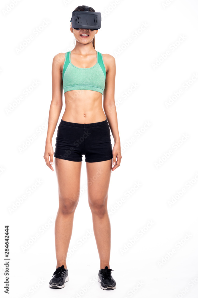Fitness woman wearing VR headset isolated in white background. Asian girl,  full body shot happy smile look. foto de Stock | Adobe Stock