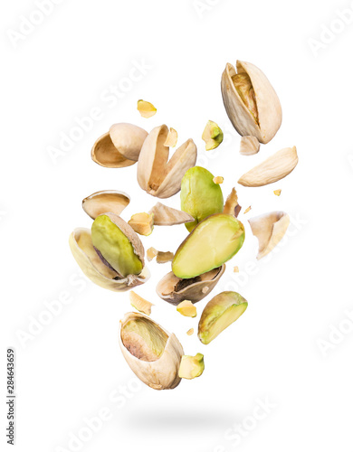 Pistachios crushed into many pieces on a white background photo
