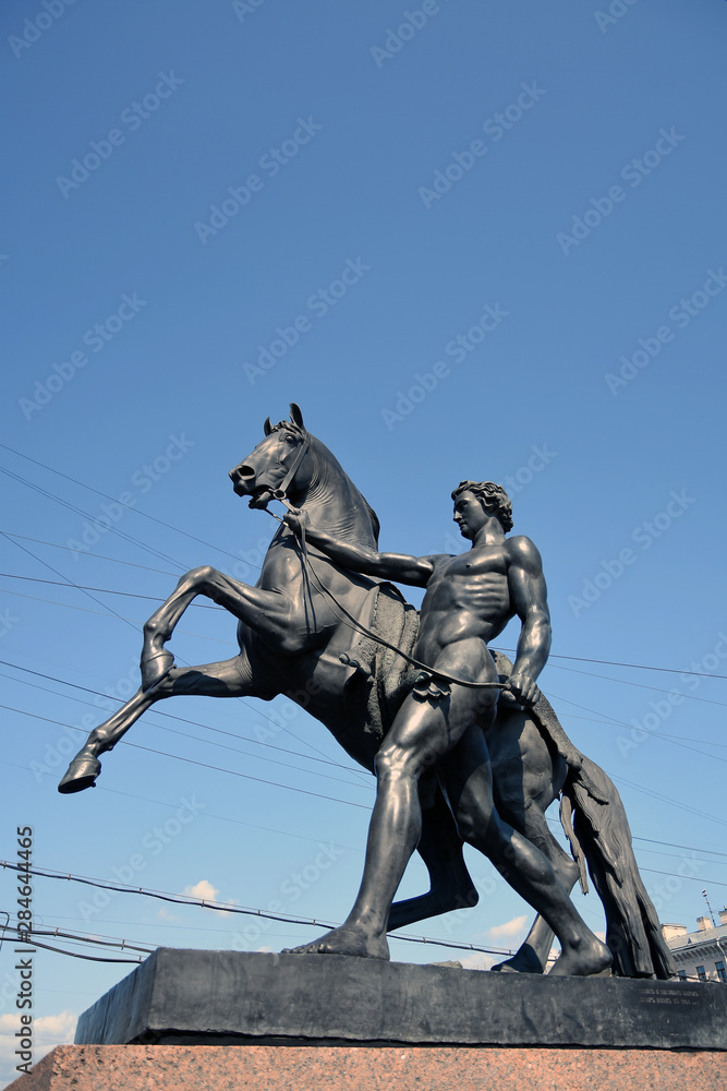 Fototapeta premium Horse tamers monument on Anichkov Bridge in Saint-Petersburg Russia. Popular touristic landmark.