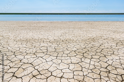 The waterside of the salt lake with dry cracked soil. Gruzskoe lake, Rostov-on-Don region, Russia