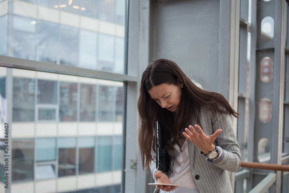 stressful young woman is a businesswoman who took an unpleasant message in a business chat.