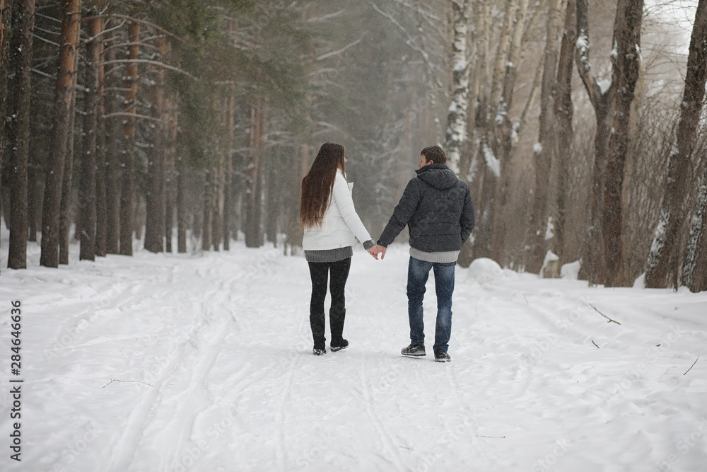 pair of lovers on a date winter afternoon in a snow blizzard pair of lovers on a date winter afternoon in a snow blizzard