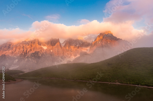 Sunset in Passo Rolle - Baita Segantini lake in Dolomite mountain range  Italy.