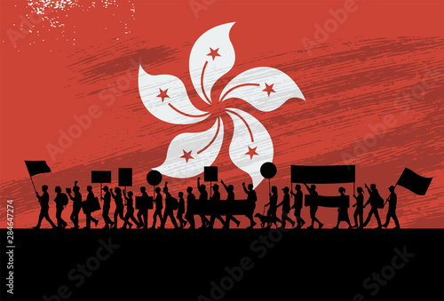 Silhouette of people protesting with a flag of Hong Kong as a background