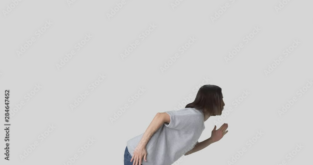 Attractive young woman dancing and singing over white background Attractive young woman dancing and singing over white background