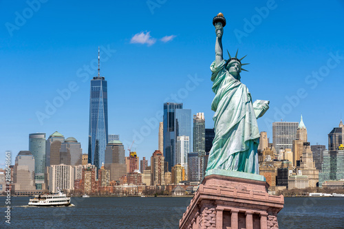 Obraz na płótnie The Statue of Liberty over the Scene of New york cityscape river side which location is lower manhattan,Architecture and building with tourist concept w salonie