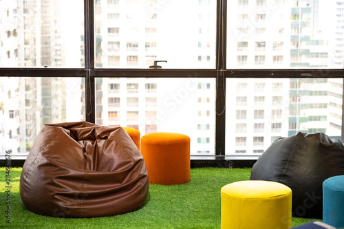 leather beanbags on fake green grass.. work place view