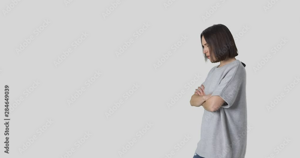 Thoughtful young woman counting on her fingers and getting a brilliant idea over white background Thoughtful young woman counting on her fingers and getting a brilliant idea over white background