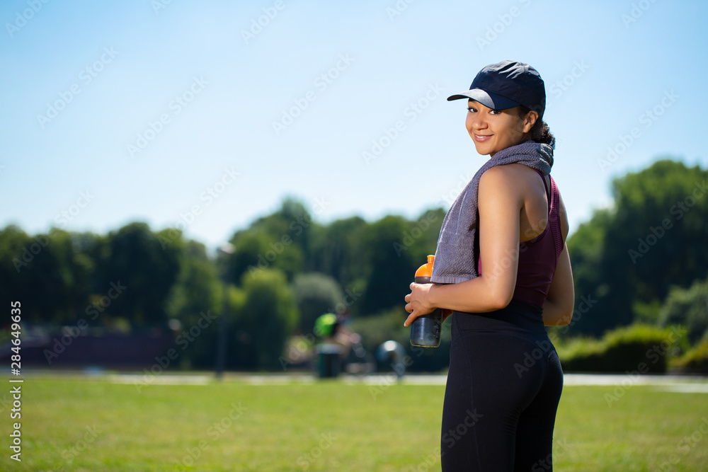 Mixed girl in a park smling after an outdoor sport session Mixed girl in a park smling after an outdoor sport session
