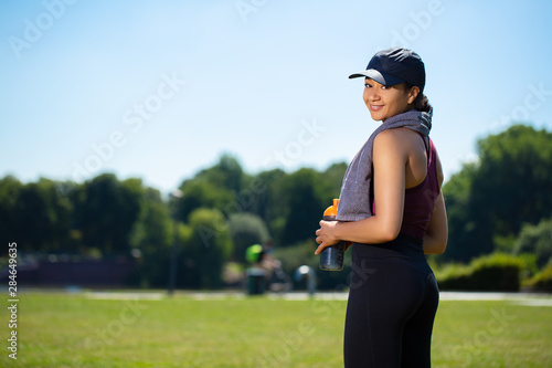 Mixed girl in a park smling after an outdoor sport session