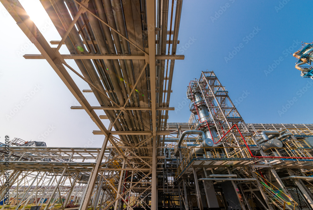 view of metal pipes of industrial plant outdoor at sunny day view of metal pipes of industrial plant outdoor at sunny day