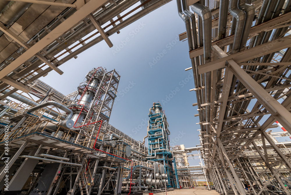 view of metal pipes of industrial plant outdoor at sunny day