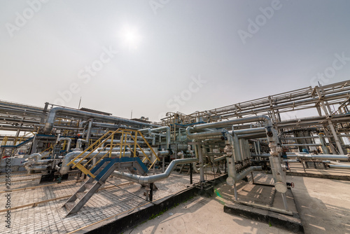 low angle view of metal pipes of industrial plant outdoor 