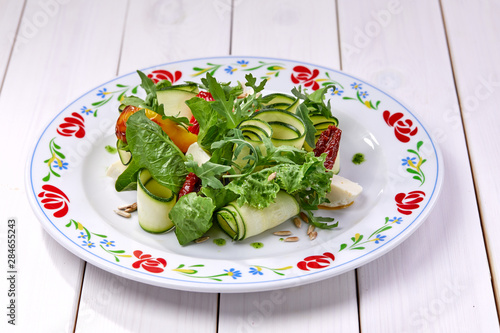 zucchini rolls with fresh salad photo