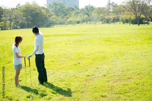 Trainer golf tutor practice for new golf player.