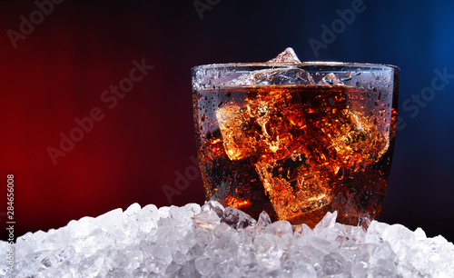 Glass of carbonated soft drink with ice photo