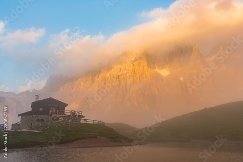 Sunset in Passo Rolle - Baita Segantini lake in Dolomite mountain range, Italy.