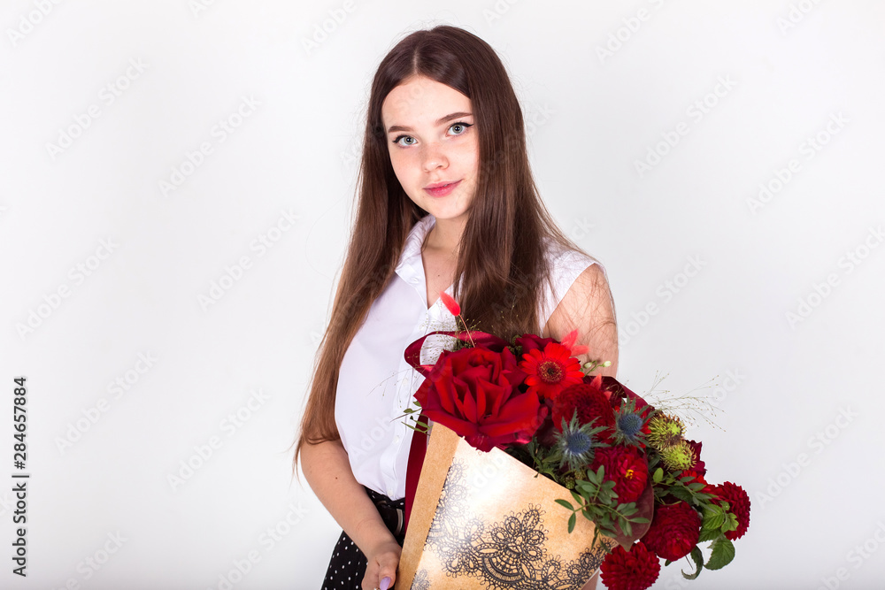 Teen girl holding flowers on white isolated backgroung smiling and happy. Childhood, floral concept Teen girl holding flowers on white isolated backgroung smiling and happy. Childhood, floral concept