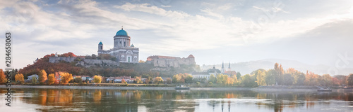 Esztergom, Hungary, view on Basilica. Beautiful light Morning misty panorama over Danube river on border of Hungary and Slovakia. Banner for web-design format photo. Autumn season, yellow trees. © Feel good studio