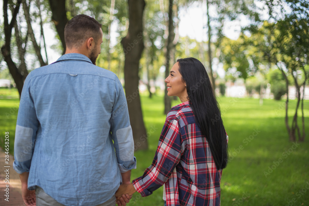 loving couple walking in the park and hugging, beautiful guy and girl loving couple walking in the park and hugging, beautiful guy and girl