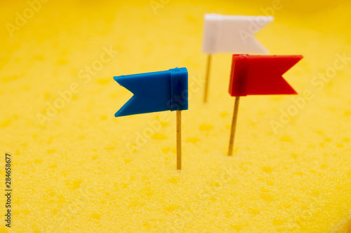 pushpin flag over yellow board photo