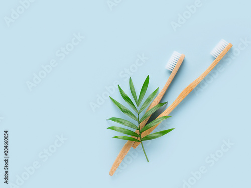 Zero waste and minimalism concept. Wooden  bamboo thoothbrush ecological  theme on blue background