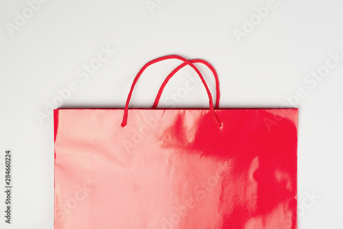 Sale and black friday falt lay concept with red  shopping bag  on white background photo