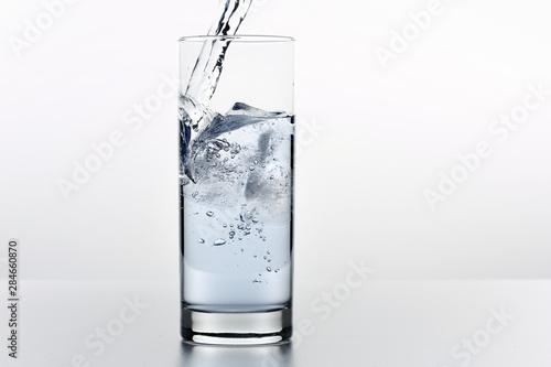 Beautiful splash of water in a glass with ice