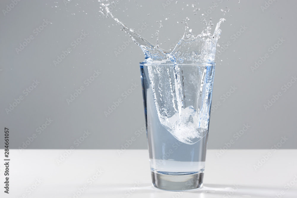 Beautiful splash of water in a glass with ice Beautiful splash of water in a glass with ice