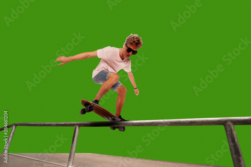 Skateboarder on green screen background.