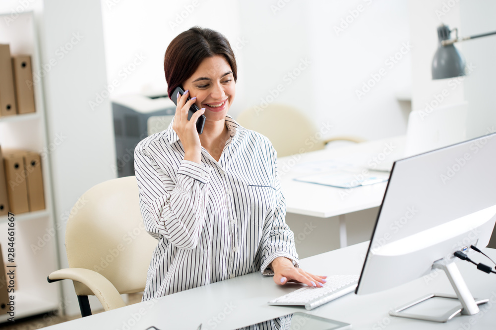 Business woman talking on the phone in the office