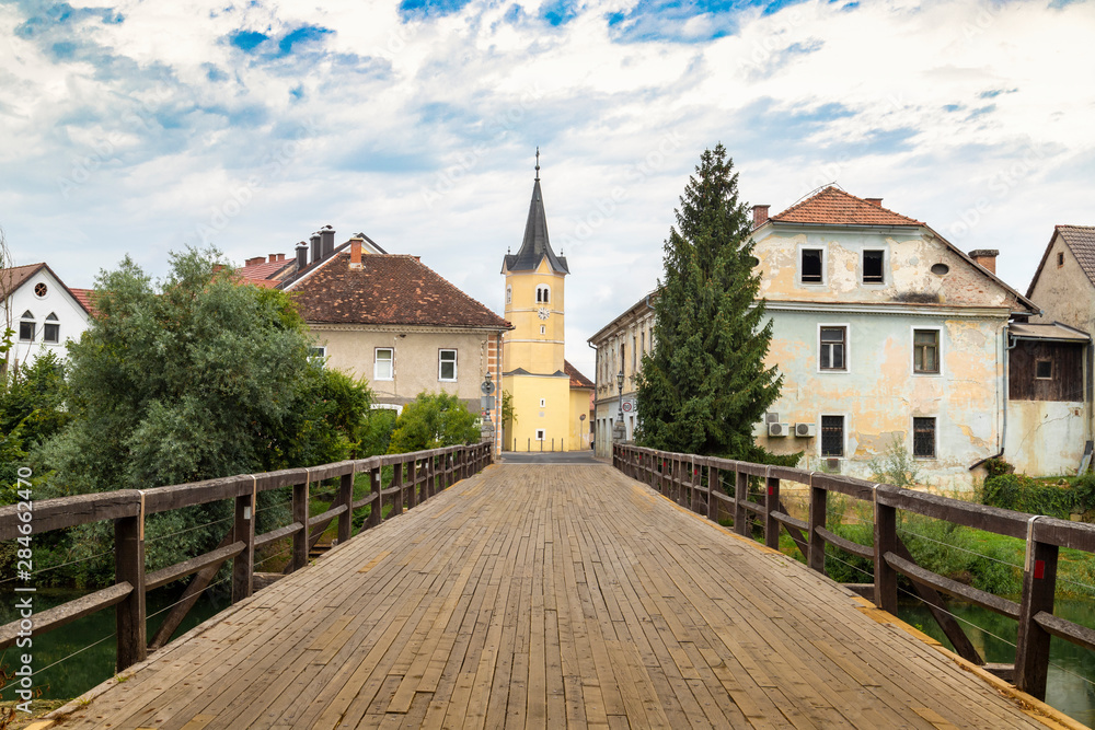 Kostanjevica na Krki, the wooden bridge on the river Krki at the entrance of the village