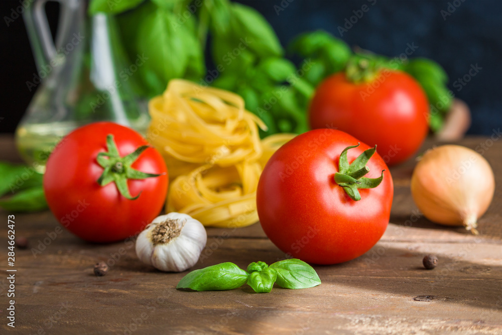 fresh tomatoes garlic onion fettuccine ingredients for cooking vegetarian pasta close up fresh tomatoes garlic onion fettuccine ingredients for cooking vegetarian pasta close up