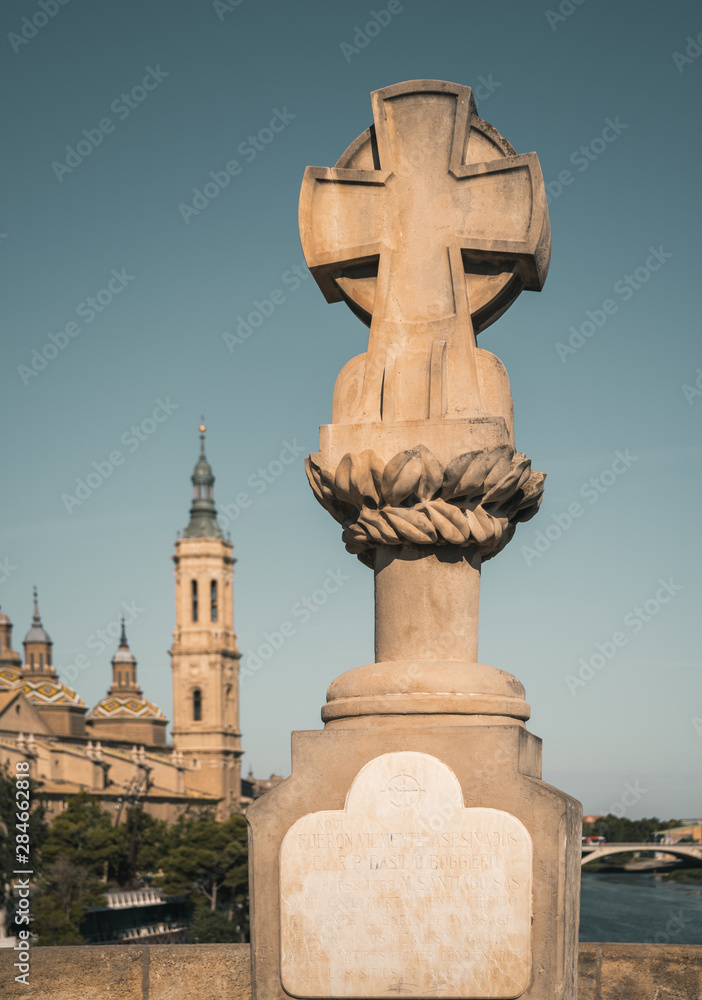 View of Basil's cross on Stone Bridge and Basilica Pilar in Zaragoza , Spain.