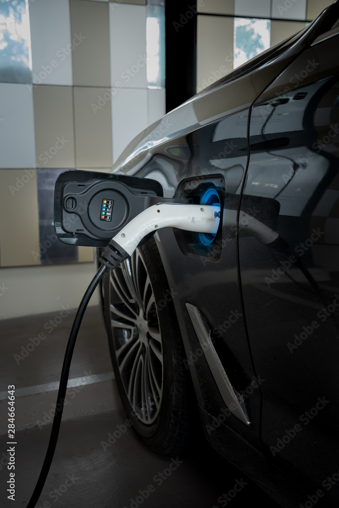 EV Car. Electric car. Charging Station with the power cable plugged in.Technology car. A Future transport. Recharging. High technology . Transportation EV. Transport EV car. Innovation future.