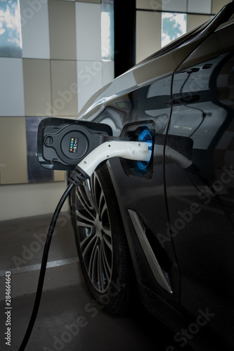 EV Car. Electric car. Charging Station with the power cable plugged in.Technology car. A Future transport. Recharging. High technology . Transportation EV. Transport EV car. Innovation future.