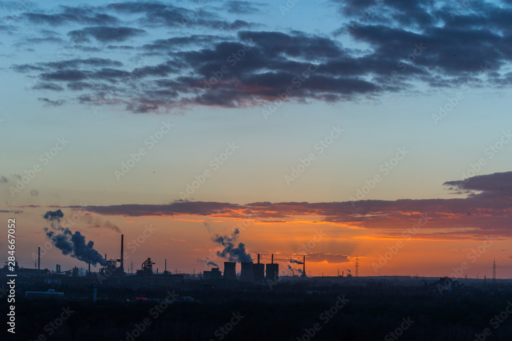 Sonnenuntergang an der Sechs-Seen-Platte in Duisburg mit Blick auf die rauchenden Schlote am Horizont