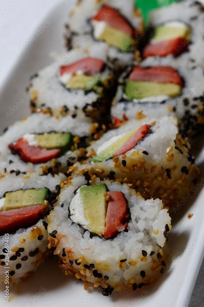 Sushi is traditionally made with medium-grain white rice. It is very often prepared with seafood, such as squid, eel, yellowtail, salmon, tuna or imitation crab meat. Sushi is traditionally made with medium-grain white rice. It is very often prepared with seafood, such as squid, eel, yellowtail, salmon, tuna or imitation crab meat.
