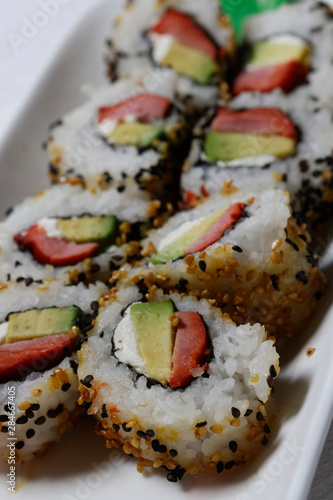 Sushi is traditionally made with medium-grain white rice. It is very often prepared with seafood, such as squid, eel, yellowtail, salmon, tuna or imitation crab meat.