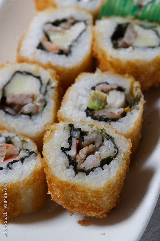 Sushi is traditionally made with medium-grain white rice. It is very often prepared with seafood, such as squid, eel, yellowtail, salmon, tuna or imitation crab meat.