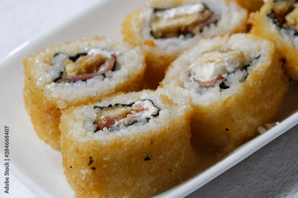 Sushi is traditionally made with medium-grain white rice. It is very often prepared with seafood, such as squid, eel, yellowtail, salmon, tuna or imitation crab meat. Sushi is traditionally made with medium-grain white rice. It is very often prepared with seafood, such as squid, eel, yellowtail, salmon, tuna or imitation crab meat.