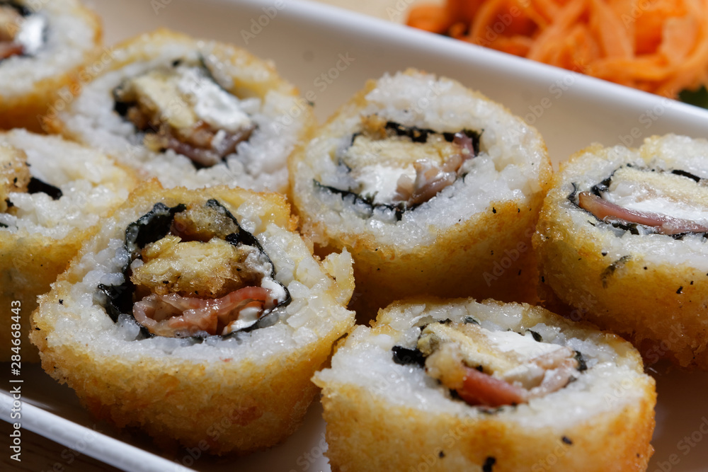 Sushi is traditionally made with medium-grain white rice. It is very often prepared with seafood, such as squid, eel, yellowtail, salmon, tuna or imitation crab meat. Sushi is traditionally made with medium-grain white rice. It is very often prepared with seafood, such as squid, eel, yellowtail, salmon, tuna or imitation crab meat.